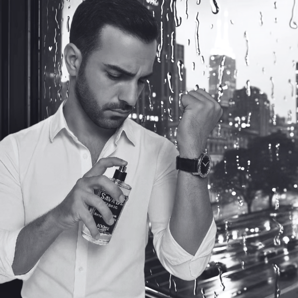 Man spraying cologne with a cityscape in the background